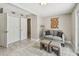 Bedroom features a neutral paint color, wood-look tile flooring, a double closet, and lots of natural light at 536 W King St, Orlando, FL 32804