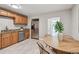 Kitchen features stainless steel appliances, wood cabinets, and a dining area at 536 W King St, Orlando, FL 32804