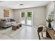 Cozy living room features neutral decor, lots of natural light, and access to the backyard through glass doors at 536 W King St, Orlando, FL 32804