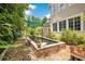 Lush backyard features a koi pond with brick surround, framed by mature trees, and with multiple large windows at 614 Lake Ave, Orlando, FL 32801