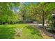 Beautiful backyard with lush greenery, wrought iron benches, and decorative elements, creating a serene outdoor space at 614 Lake Ave, Orlando, FL 32801