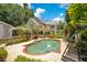 Charming backyard with a pool, lush greenery, and a view of the house, perfect for relaxation and entertainment at 614 Lake Ave, Orlando, FL 32801