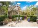Charming backyard with lush greenery, quaint seating area, and a pergola-covered space, perfect for outdoor enjoyment at 614 Lake Ave, Orlando, FL 32801
