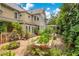 Lush backyard with brick-paved area featuring a raised garden bed and charming landscaping near house and windows at 614 Lake Ave, Orlando, FL 32801
