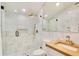 Luxurious bathroom features a glass-enclosed shower, marble tile, and a wooden vanity at 614 Lake Ave, Orlando, FL 32801