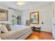 Bright bedroom featuring a mirror, benches, large window and gleaming hardwood floors at 614 Lake Ave, Orlando, FL 32801