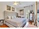 Bright bedroom featuring a tufted headboard, unique artwork, and gleaming hardwood floors at 614 Lake Ave, Orlando, FL 32801
