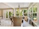 Bright breakfast nook with a cushioned banquette seating, chandelier and view to outside at 614 Lake Ave, Orlando, FL 32801