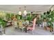 Sunroom dining area with surrounding plants, glass table, and decorative chairs at 614 Lake Ave, Orlando, FL 32801