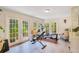 Bright exercise room with multiple French doors leading to the outdoors and a selection of gym equipment at 614 Lake Ave, Orlando, FL 32801