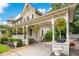 Classic home with porte cochere, hanging ferns, and meticulously maintained landscaping creates a welcoming entrance at 614 Lake Ave, Orlando, FL 32801