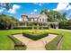 Classic home features a manicured lawn, tasteful landscaping, and a welcoming path to the front porch at 614 Lake Ave, Orlando, FL 32801