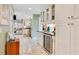 Bright kitchen with white cabinets, stainless appliances, and a wine refrigerator at 614 Lake Ave, Orlando, FL 32801