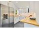 Bright kitchen with stainless steel appliances, white cabinets, and butcher block countertops at 614 Lake Ave, Orlando, FL 32801