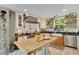 Well-lit kitchen featuring a large island, modern appliances, and open shelving at 614 Lake Ave, Orlando, FL 32801