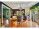 Charming living room with hardwood floors, unique light fixtures, and views to other living spaces at 614 Lake Ave, Orlando, FL 32801