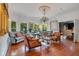 Spacious living room with hardwood floors, decorative ceiling, fireplace, chandelier and plentiful natural light at 614 Lake Ave, Orlando, FL 32801