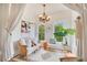 Bright sitting room featuring a decorative chandelier, neutral furniture, and lush plants for a cozy and inviting atmosphere at 614 Lake Ave, Orlando, FL 32801