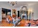 Spacious living room with hardwood floors, chandelier and decorated fireplace at 614 Lake Ave, Orlando, FL 32801