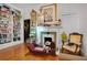 Bright living room featuring an ornate fireplace, wood floors, large windows and a beautiful bookshelf at 614 Lake Ave, Orlando, FL 32801