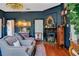 Elegant living room features hardwood floors, fireplace, and dark blue walls at 614 Lake Ave, Orlando, FL 32801