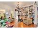 Bright living room featuring hardwood floors, large bookshelves, and a decorative chandelier at 614 Lake Ave, Orlando, FL 32801