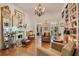 Living room with fireplace, chandelier, hardwood floors, bookshelves and an ornate gold mirror at 614 Lake Ave, Orlando, FL 32801