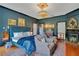 Dark and luxurious primary bedroom with a stunning bed, elegant lighting, and cozy fireplace, perfect for relaxation at 614 Lake Ave, Orlando, FL 32801