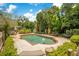 Inviting backyard pool with brick trim, surrounded by lush landscaping, statues, and a tranquil hanging chair at 614 Lake Ave, Orlando, FL 32801