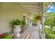 Charming front porch with potted plants, ferns, and decorative touches adds to the home's inviting appeal at 614 Lake Ave, Orlando, FL 32801
