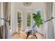 Bright sitting area with large windows, hardwood floors, and lush greenery, creating a serene and relaxing space at 614 Lake Ave, Orlando, FL 32801