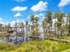 Scenic water view featuring a dock and lush trees, offering a tranquil escape into nature with peaceful surroundings at 614 Lake Ave, Orlando, FL 32801