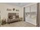Cozy bedroom showcases a tufted sofa, window views, and natural light, creating a relaxing ambiance at 6527 Silver Queen Way, Windermere, FL 34786