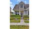 Inviting townhome showcasing a well-manicured front yard, a stylish front door, and classic architectural details at 6527 Silver Queen Way, Windermere, FL 34786