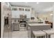Bright kitchen with stainless steel appliances, granite countertops and a stylish kitchen island with seating at 6527 Silver Queen Way, Windermere, FL 34786