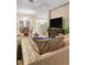 Relaxing living room featuring a spacious sofa, a modern TV, and an adjacent dining area for easy entertaining at 6527 Silver Queen Way, Windermere, FL 34786