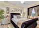 Luxurious main bedroom with a plush bed, elegant decor, and a cozy window seat for added charm at 6527 Silver Queen Way, Windermere, FL 34786