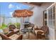 Inviting patio features stylish wicker furniture, a grill, and a unique umbrella for comfortable outdoor living at 6527 Silver Queen Way, Windermere, FL 34786
