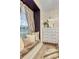 Charming window seat featuring plush cushions, elegant curtains, and a view of a decorative dresser with mirror at 6527 Silver Queen Way, Windermere, FL 34786