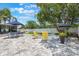 Serene backyard with seating area, lush landscaping and a shade tree at 719 Stevelynn Cir, Winter Garden, FL 34787