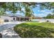 Lush backyard featuring a screened patio, storage shed, and well-manicured lawn at 719 Stevelynn Cir, Winter Garden, FL 34787