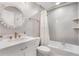 Stylish bathroom features white vanity, decorative mirror and bathtub with shower at 719 Stevelynn Cir, Winter Garden, FL 34787