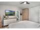 Bright bedroom featuring a flat screen TV, dresser, and a glimpse into the en-suite bathroom at 719 Stevelynn Cir, Winter Garden, FL 34787