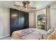 Comfortable bedroom features modern ceiling fan, custom black closet with lots of storage, and cozy design at 719 Stevelynn Cir, Winter Garden, FL 34787
