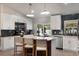 Bright and airy kitchen with white cabinets, center island with seating and modern appliances at 719 Stevelynn Cir, Winter Garden, FL 34787