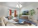 Bright living room with comfortable sectional, a bay window, stylish lighting, and contemporary decor at 719 Stevelynn Cir, Winter Garden, FL 34787