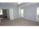Spacious bedroom with light gray walls, neutral carpet, and natural light from the windows at 8025 Old Town Dr, Orlando, FL 32819