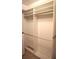 Open closet featuring custom shelving, rods, and carpeted floors at 8025 Old Town Dr, Orlando, FL 32819