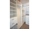 Walk-in closet with custom shelving, drawers, and carpeted floors at 8025 Old Town Dr, Orlando, FL 32819