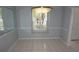 The dining room is bright with natural lighting, tile flooring, and modern lighting fixtures at 8025 Old Town Dr, Orlando, FL 32819